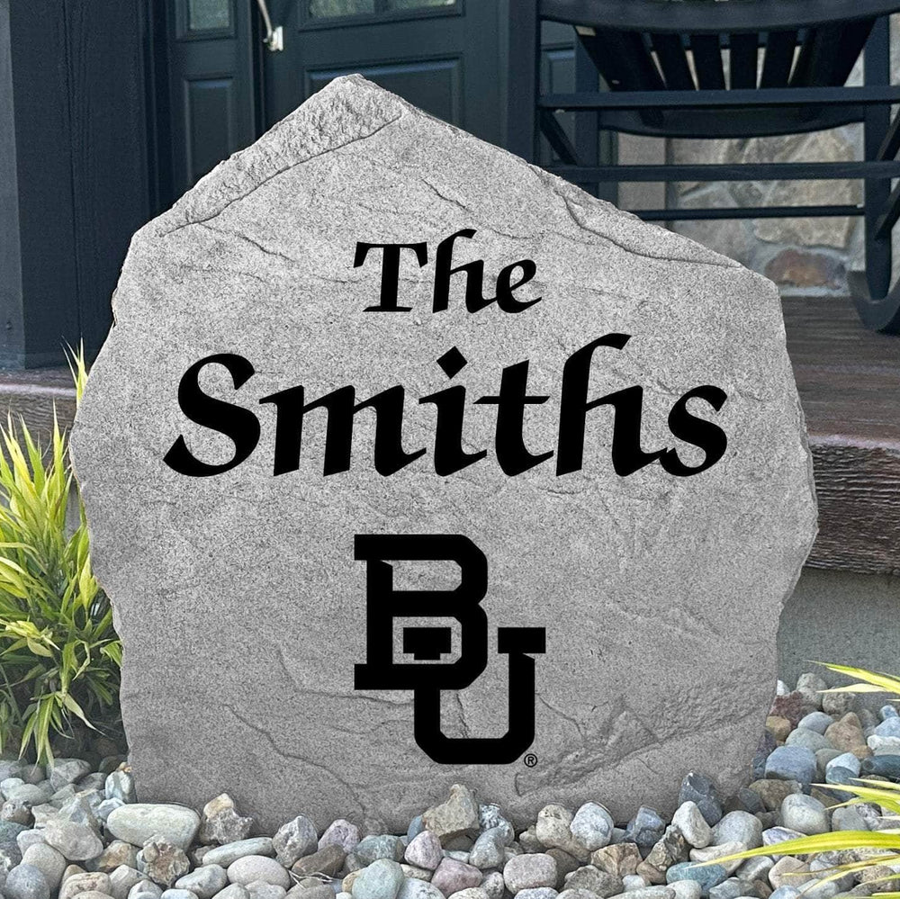 Custom Baylor University Name Stone displayed in a landscaped flower bed, showcasing personalized family lettering and officially licensed Baylor Bears artwork. This decorative outdoor stone creates a beautiful focal point for alumni homes and Baylor fans.