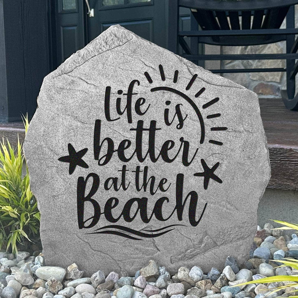 Decorative beach-themed garden stone featuring the phrase "Life Is Better At The Beach," perfect for adding seaside personality to outdoor living spaces.