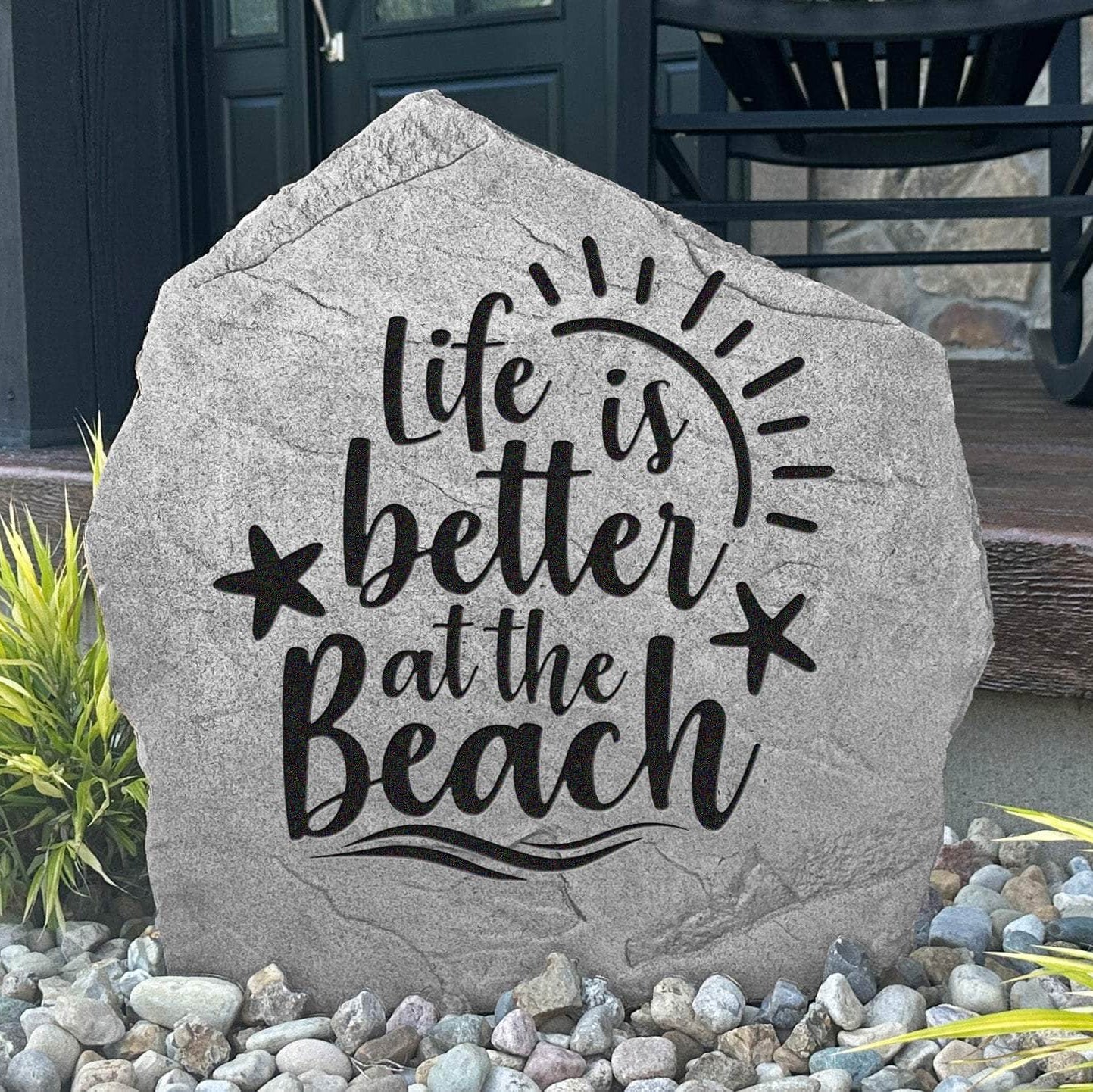 Decorative beach-themed garden stone featuring the phrase "Life Is Better At The Beach," perfect for adding seaside personality to outdoor living spaces.