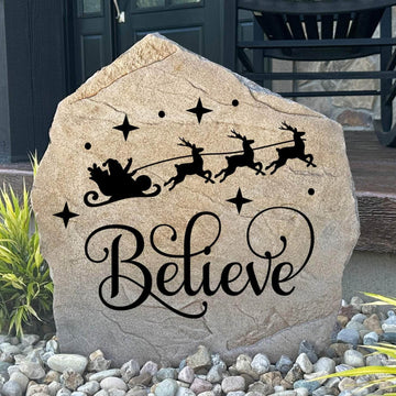 Engraved Believe Holiday Stone featuring a festive seasonal message carved directly into the stone surface. This decorative Christmas garden stone adds warmth and holiday charm to front porches, entryways, patios, and winter landscapes.