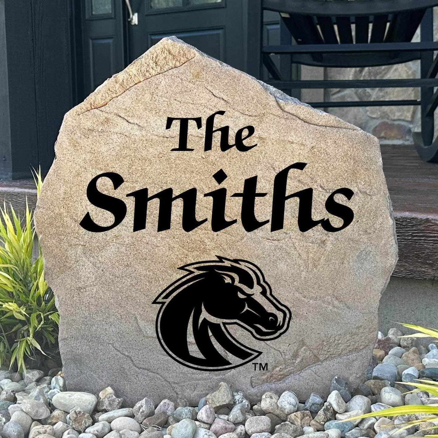 Officially licensed Boise State University Name Stone featuring a personalized family name and the iconic Boise State Broncos logo engraved directly into the stone surface. This custom garden stone adds school pride and curb appeal to front yards, patios, gardens, and entryways.