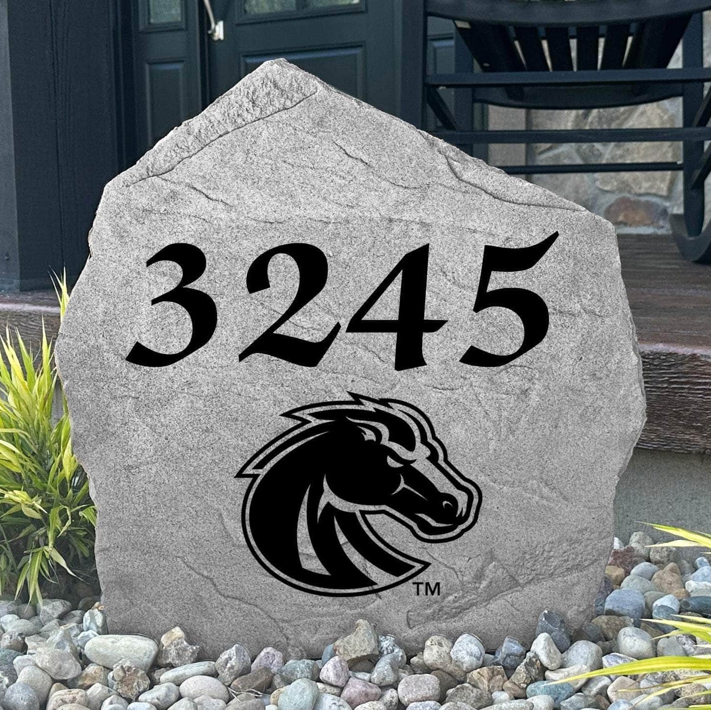 Custom Boise State University Address Stone displayed in a landscaped flower bed with personalized house numbers and officially licensed Boise State Broncos artwork. This engraved address marker creates a striking focal point for alumni homes and devoted Broncos fans.
