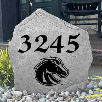 Custom Boise State University Address Stone displayed in a landscaped flower bed with personalized house numbers and officially licensed Boise State Broncos artwork. This engraved address marker creates a striking focal point for alumni homes and devoted Broncos fans.