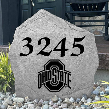 Custom Ohio State University Address Stone displayed in a landscaped flower bed with personalized house numbers and officially licensed Ohio State Buckeyes artwork. This engraved address marker creates a striking focal point for alumni homes and devoted Buckeyes fans.