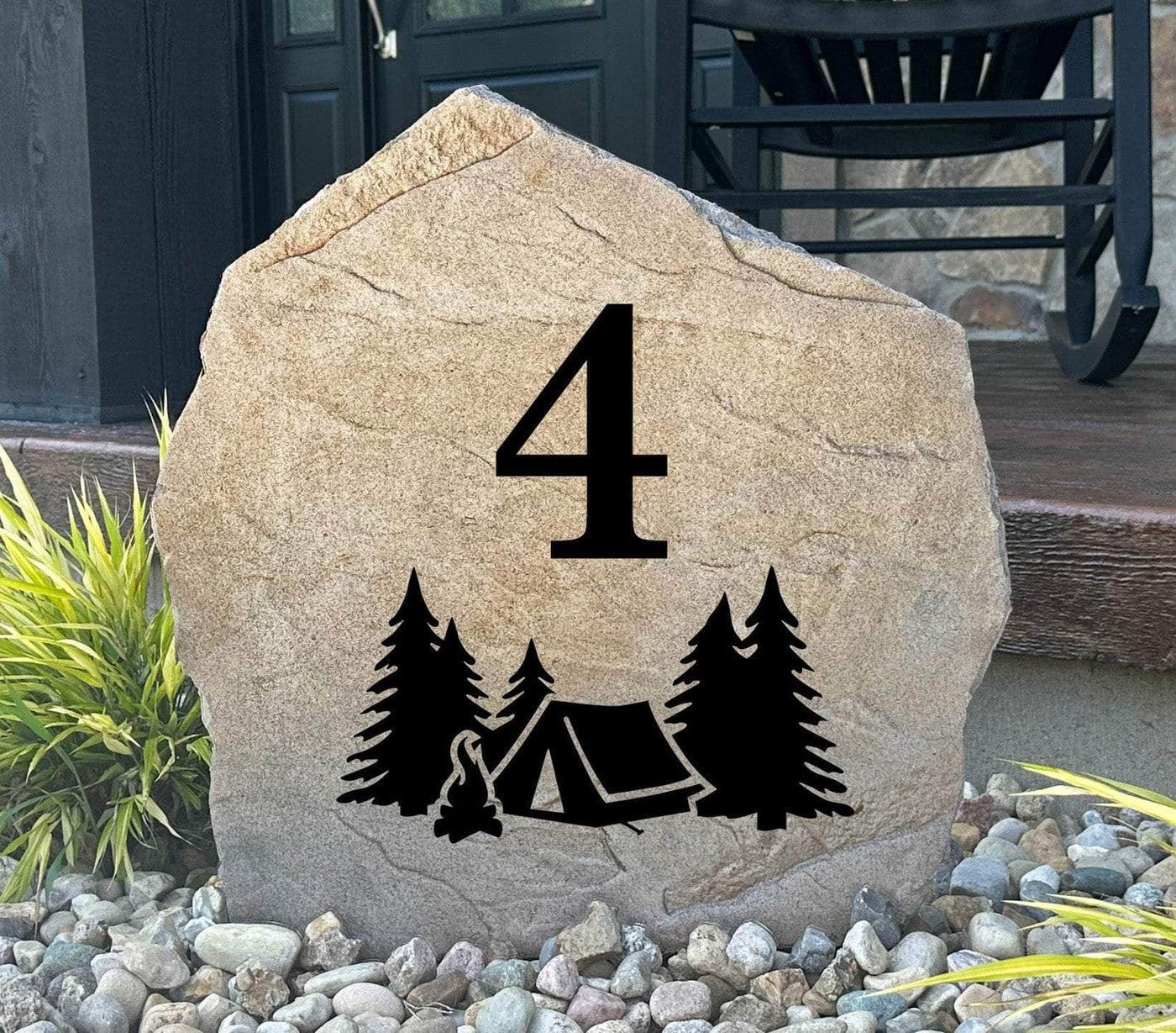Personalized campsite address stone with engraved number, tent, trees, and firepit.