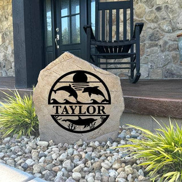 Decorative Dolphin Monogram Stone featuring graceful dolphin accents and a custom monogram permanently engraved into the stone surface. Perfect for beach houses, patios, and gardens, this outdoor stone adds timeless coastal appeal.