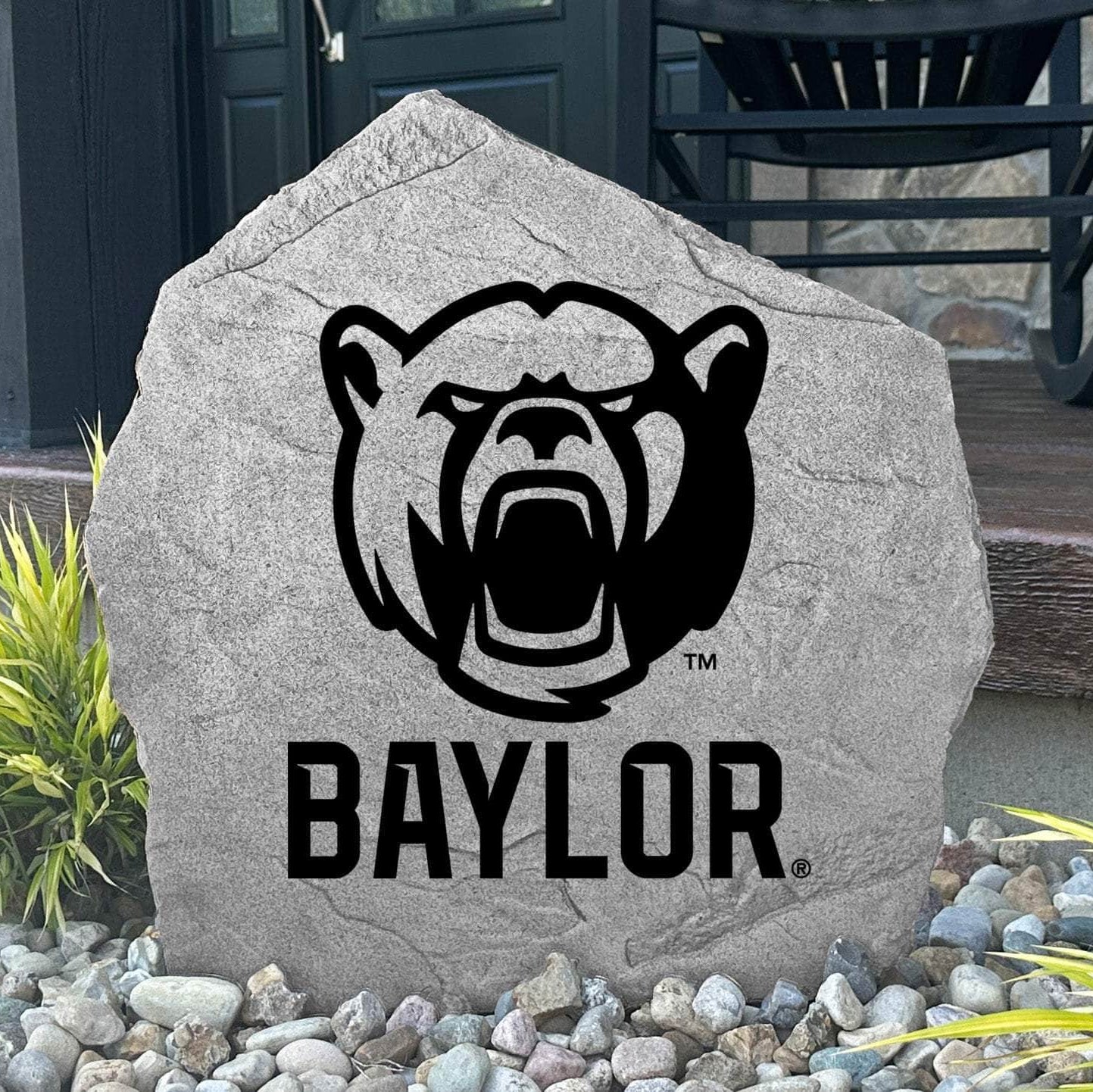 Custom Baylor Bears Bear Logo Stone displayed in a landscaped flower bed, showcasing officially licensed mascot artwork with permanent engraving. This decorative outdoor stone creates a striking focal point for alumni homes and Baylor fans.