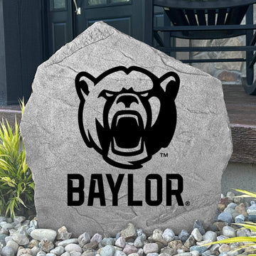 Custom Baylor Bears Bear Logo Stone displayed in a landscaped flower bed, showcasing officially licensed mascot artwork with permanent engraving. This decorative outdoor stone creates a striking focal point for alumni homes and Baylor fans.