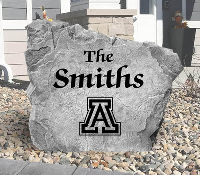 Outdoor decorative rock featuring family name and Arizona Wildcats emblem