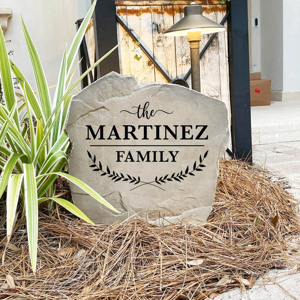 Engraved Family Name Leaf Stone nestled among colorful flowers and greenery, adding warmth and sophistication to front yard landscaping. The weather-resistant design provides lasting beauty for patios, gardens, and entryways.