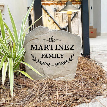 Engraved Family Name Leaf Stone nestled among colorful flowers and greenery, adding warmth and sophistication to front yard landscaping. The weather-resistant design provides lasting beauty for patios, gardens, and entryways.