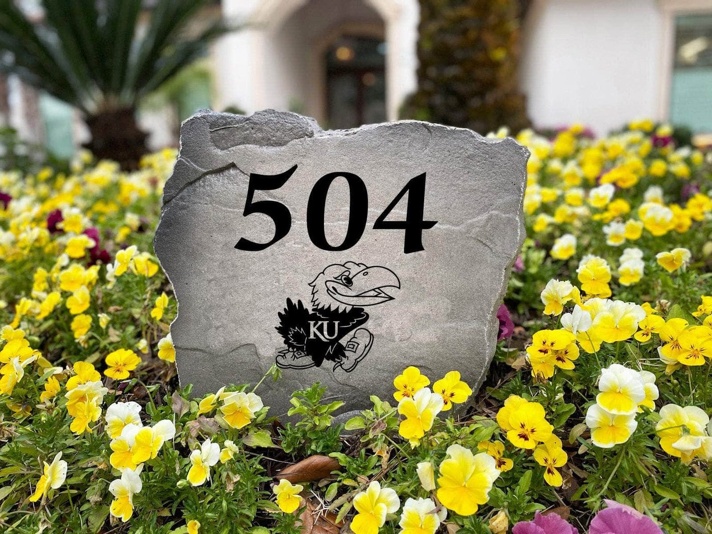 Engraved rock with University of Kansas house number design
