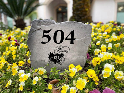 Engraved rock with University of Kansas house number design
