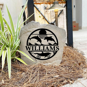 Engraved Dolphin Monogram Stone nestled among colorful flowers and natural greenery, bringing seaside style and personalized elegance to front yard landscapes and outdoor living spaces.