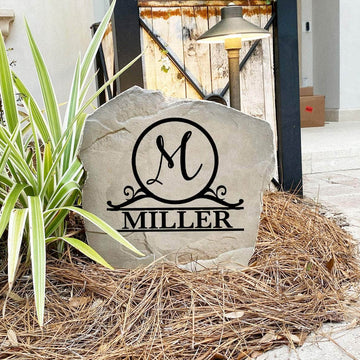 Decorative round monogram landscape stone showcasing a custom family name and initial, perfect for flower beds, walkways, and welcoming entryways.