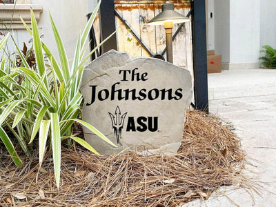 Outdoor landscaping rock with family name and Arizona State University logo