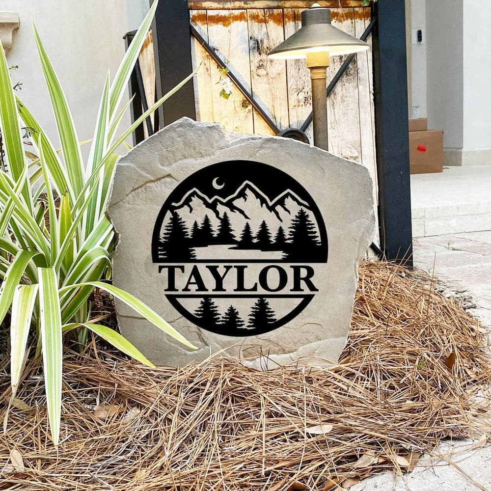 Engraved Forest Monogram Stone nestled among greenery and natural landscaping, bringing woodland beauty and personalized style to outdoor living spaces. Its weather-resistant design provides lasting elegance and durability.