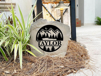Rustic landscape stone featuring forest design and custom name for home or yard.