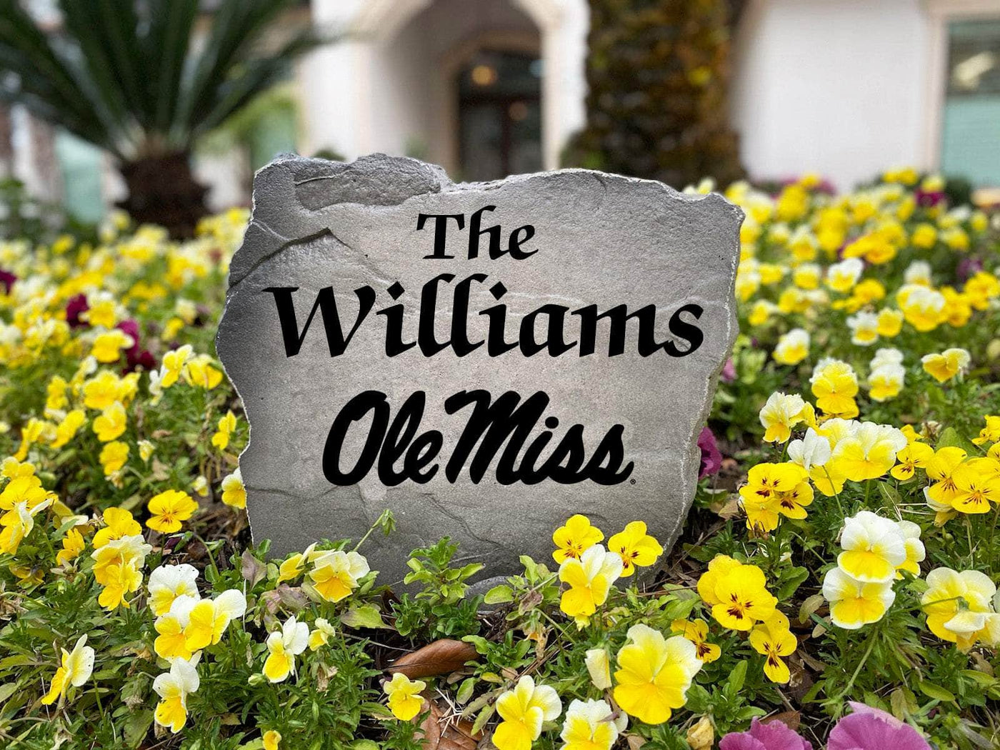 Custom outdoor name stone with Ole Miss logo for personalized home sign.