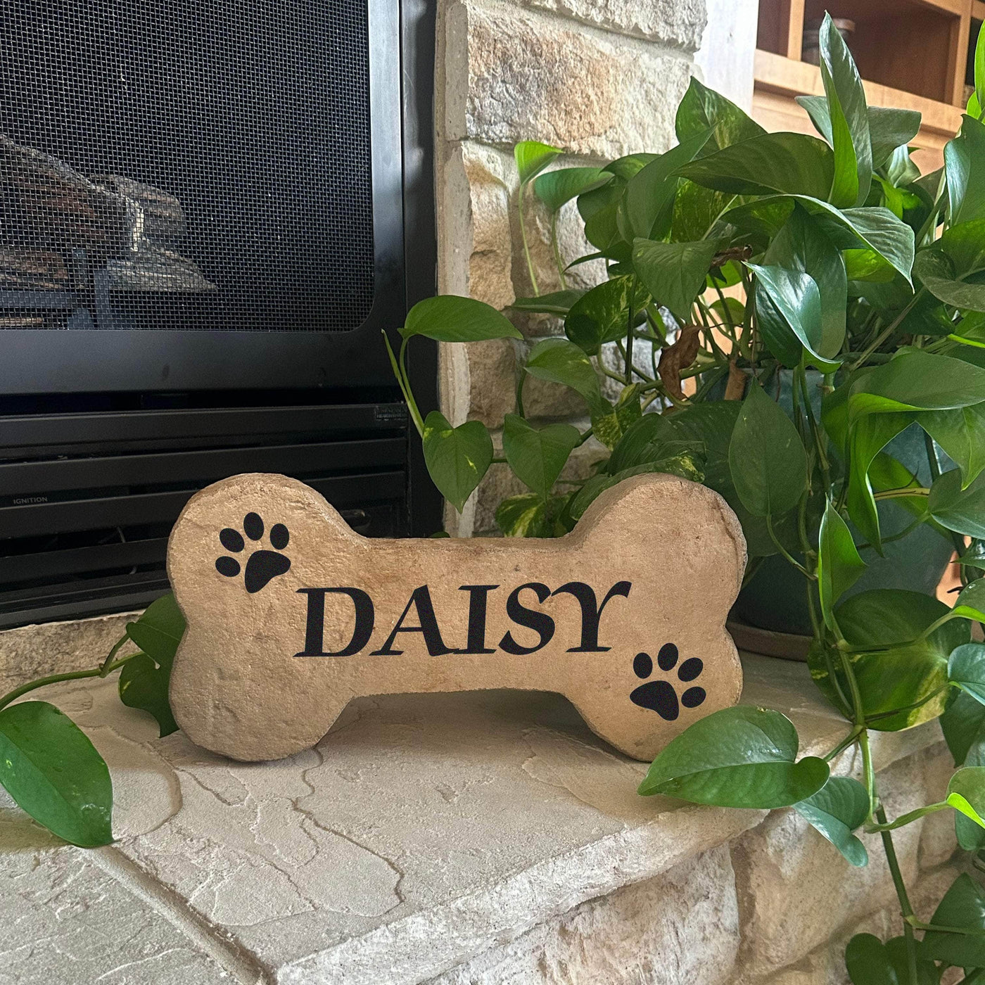 Personalized pet grave marker in DogBone shape with paw prints and engraved name.