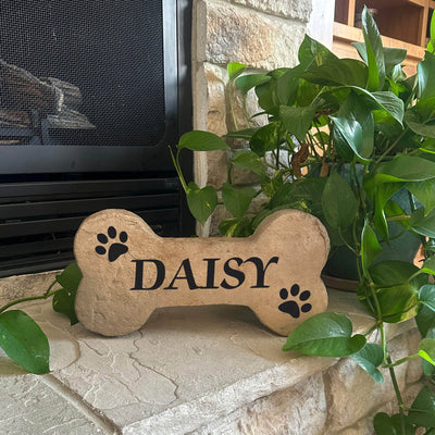 Personalized pet grave marker in DogBone shape with paw prints and engraved name.