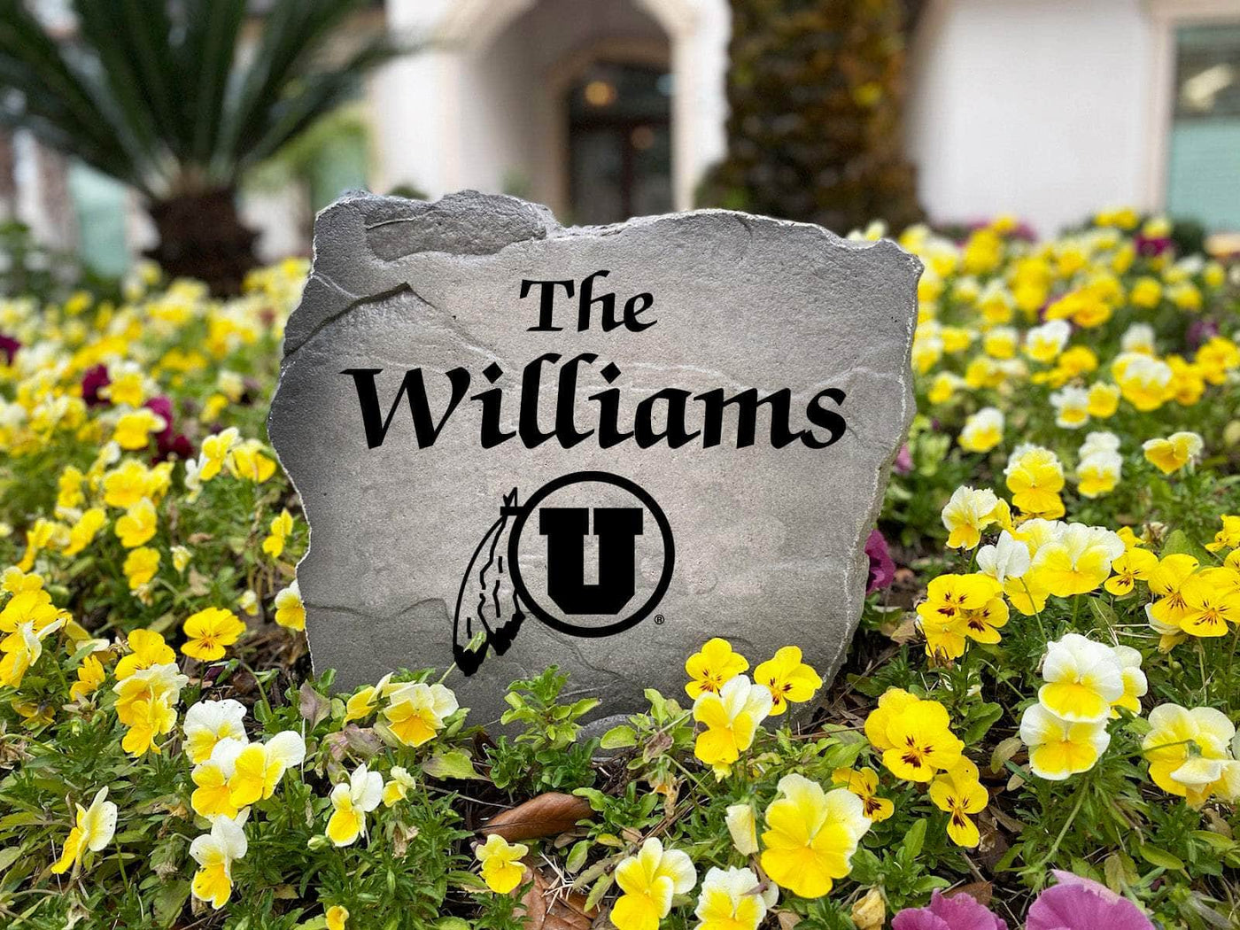 Decorative stone sign with engraved Utah Utes and custom name.