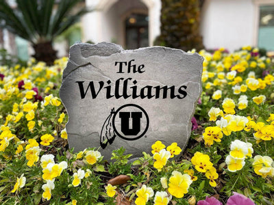 Decorative stone sign with engraved Utah Utes and custom name.