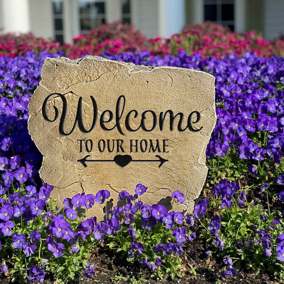 Weather-resistant Welcome To Our Home monument adding lasting charm to flower beds, patios, and front yard landscaping throughout every season.