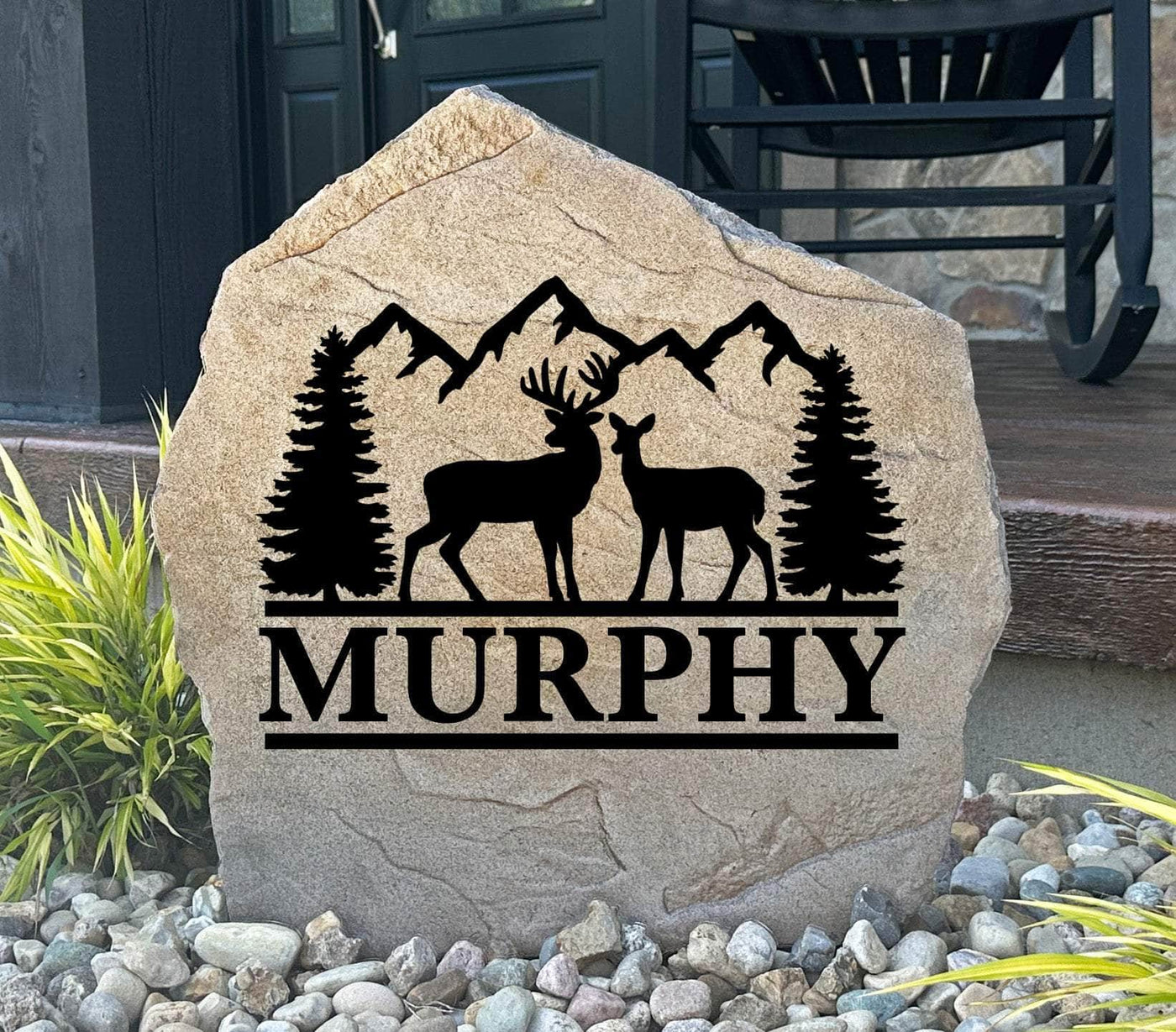 Rustic mountain stone with deer silhouette and personalized family name, perfect for outdoors.