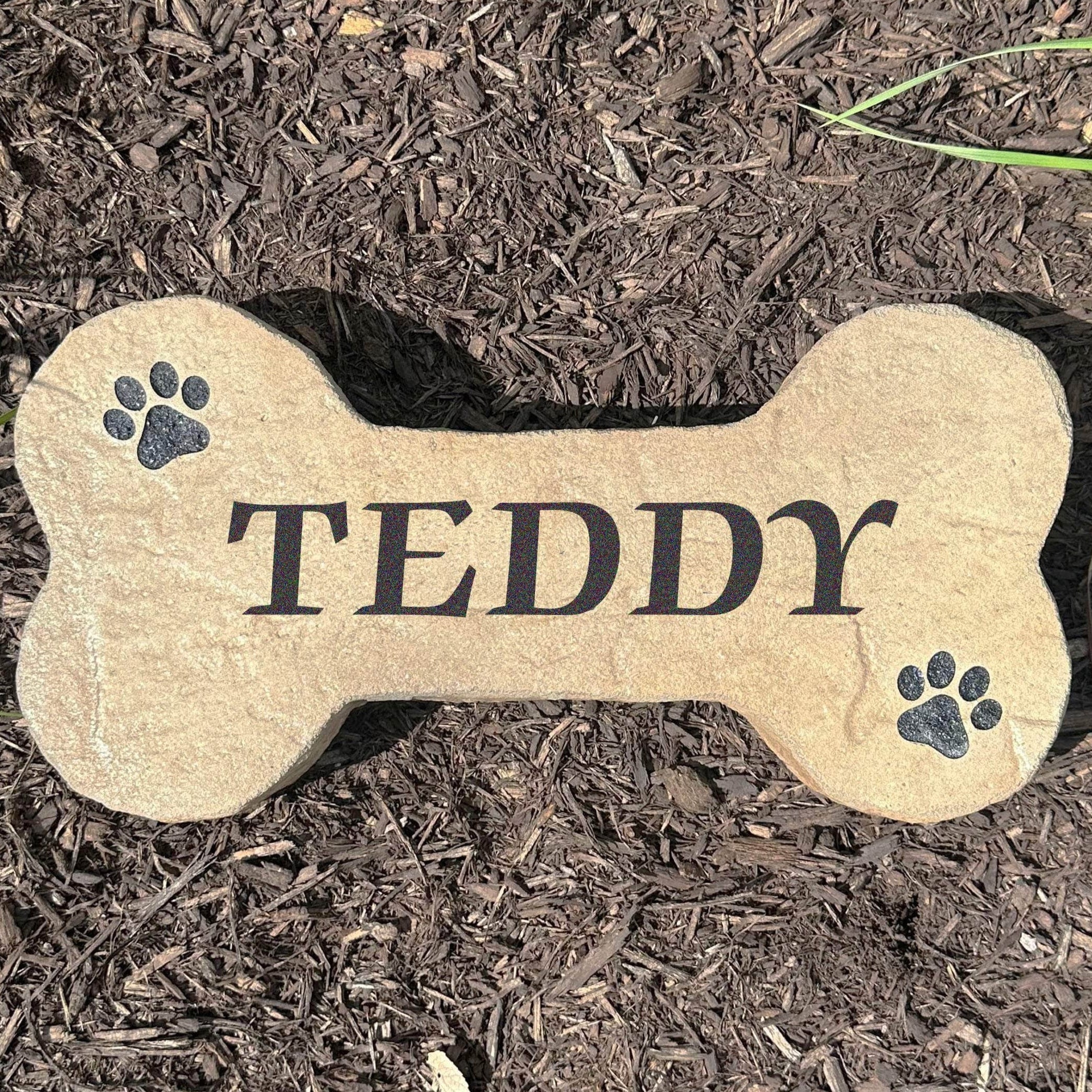 Personalized Dog Bone Stone featuring a classic bone shape and custom engraving, creating a charming accent for pet lovers. This decorative garden stone adds personality and curb appeal to front yards, patios, gardens, and entryways.