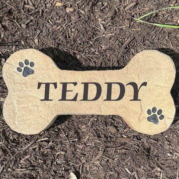 Personalized Dog Bone Stone featuring a classic bone shape and custom engraving, creating a charming accent for pet lovers. This decorative garden stone adds personality and curb appeal to front yards, patios, gardens, and entryways.