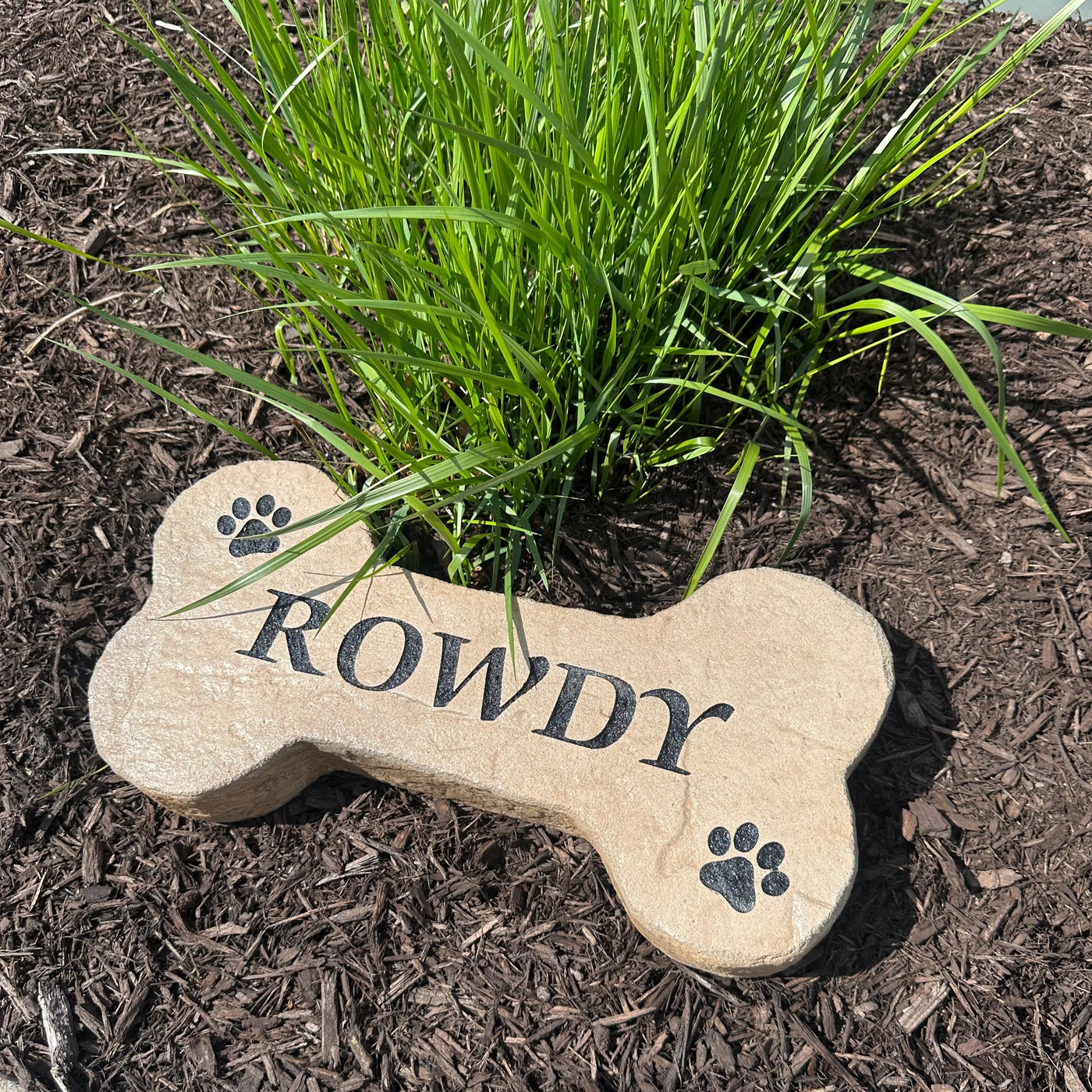 Durable engraved DogBone pet marker for outdoor memorials.
