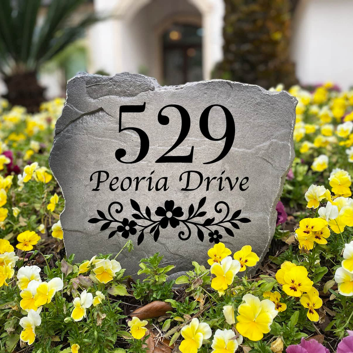 Personalized Floral Address Stone with custom house numbers and engraved floral design, handcrafted to create a beautiful address marker for front yards and gardens. The artwork and numbers are permanently engraved into the stone surface, providing a durable, weather-resistant house sign that enhances curb appeal and adds timeless elegance to walkways, driveways, and home entryways.