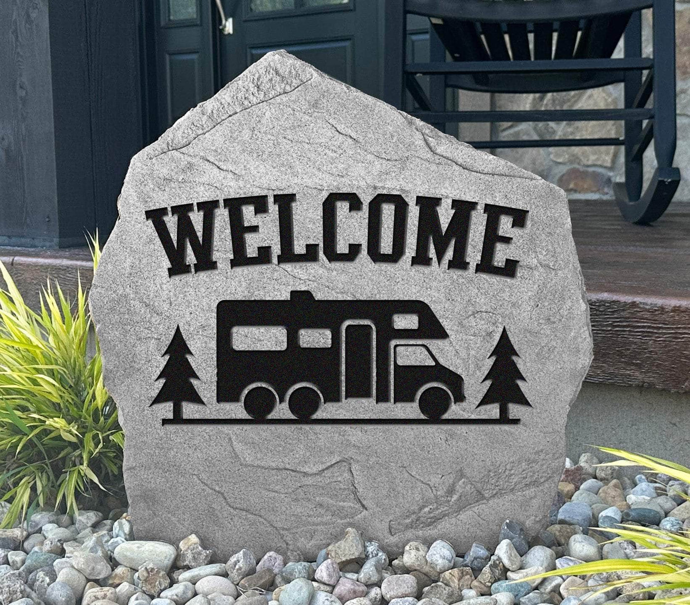 Custom engraved rock featuring RV and pine tree design.