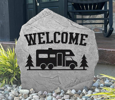 Custom engraved rock featuring RV and pine tree design.
