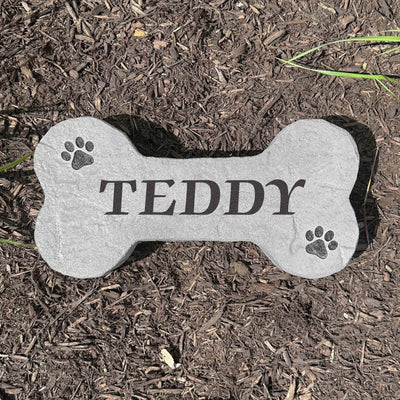 Custom engraved DogBone pet grave marker made from durable stone.