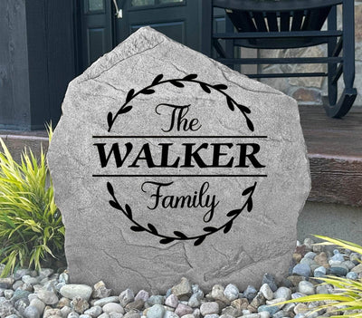 Engraved vine monogram stone featuring family name in elegant style.