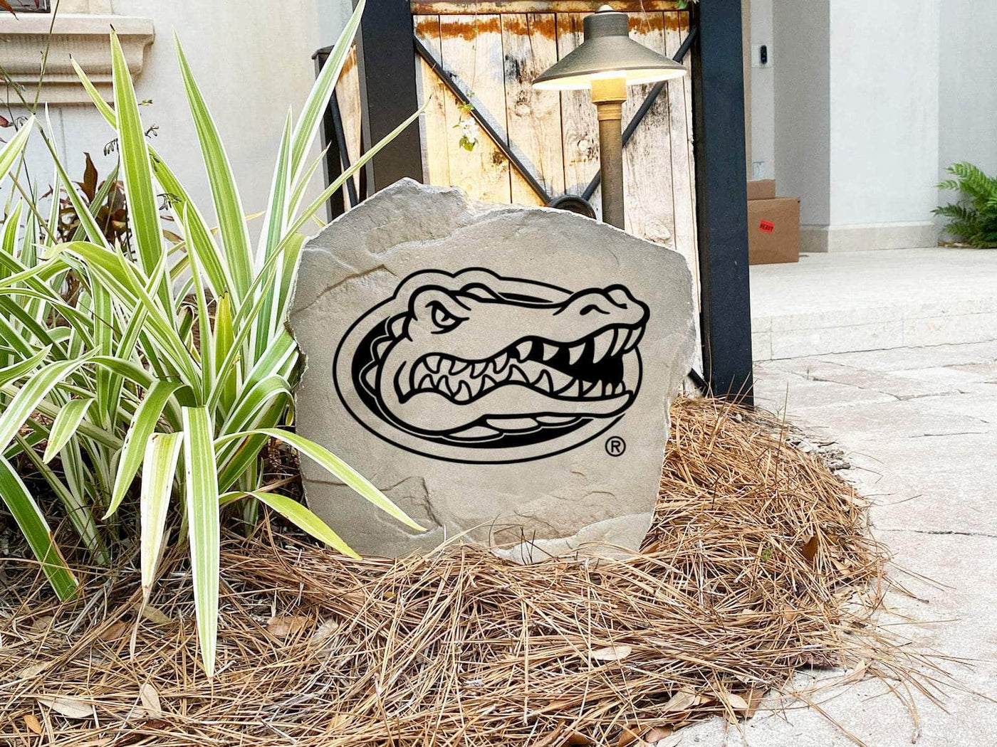 Decorative garden stone featuring University of Florida Gators logo.