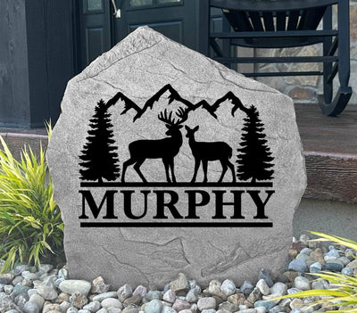 Engraved rock featuring a buck and doe with pine trees, great gift for hunters or nature lovers.