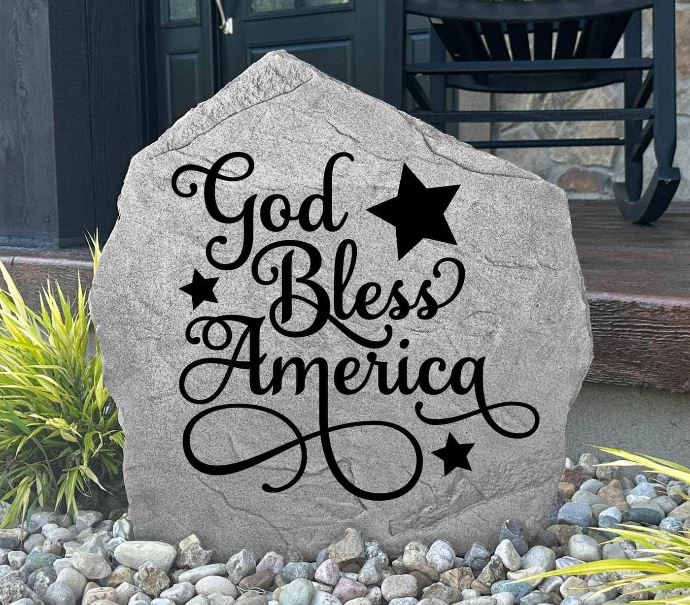 Engraved patriotic garden stone with God Bless America message.