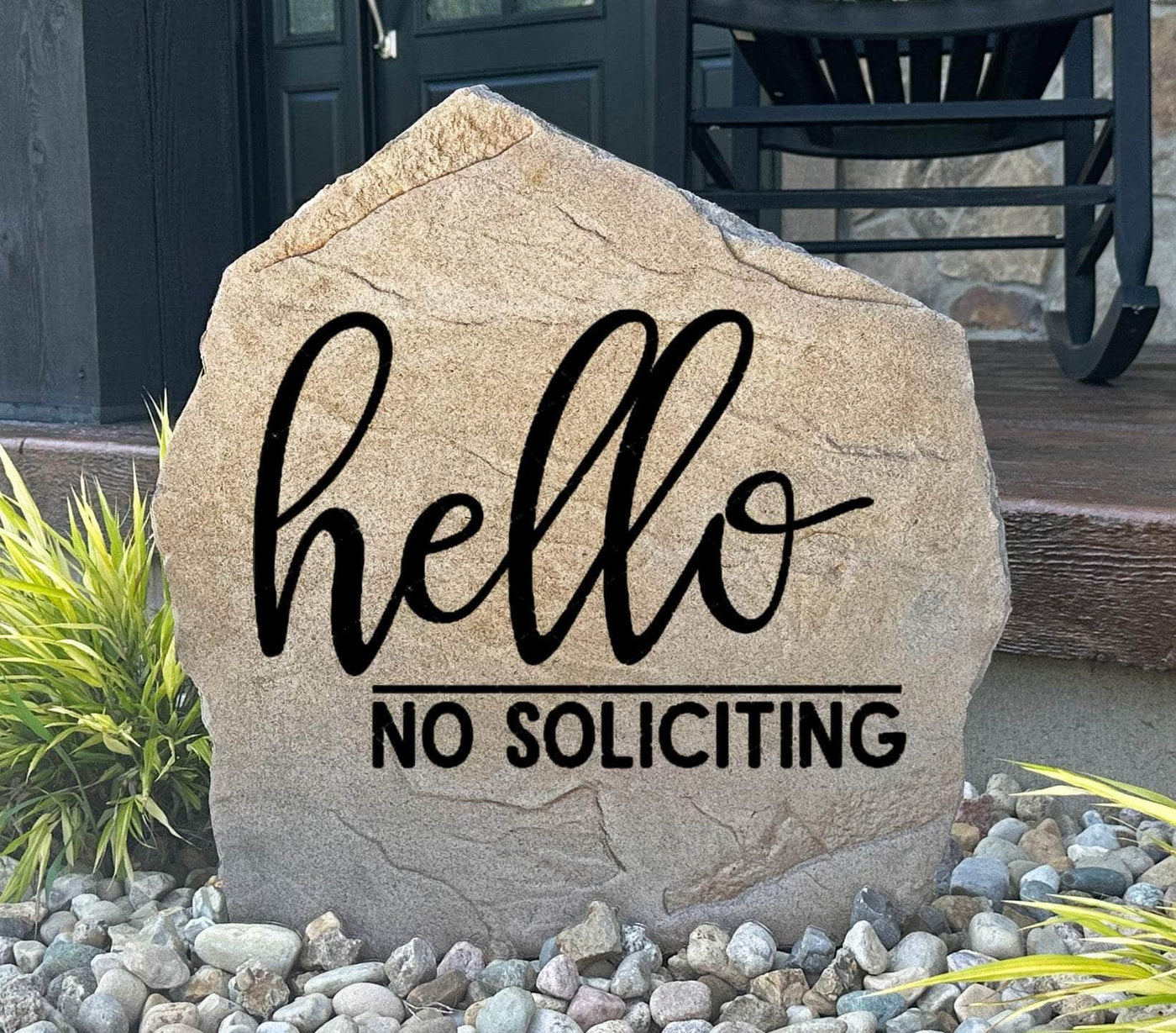 Rustic outdoor stone sign with engraved Hello No Soliciting message
