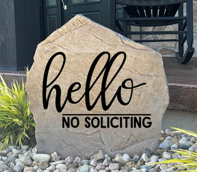 Rustic outdoor stone sign with engraved Hello No Soliciting message