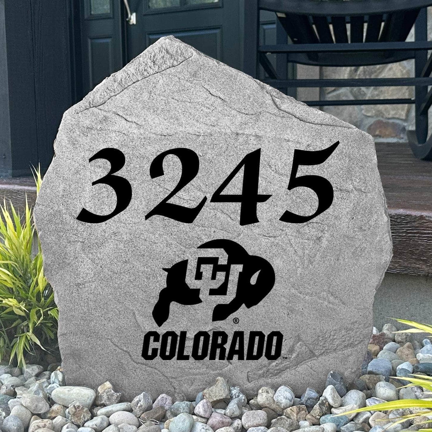 Custom University of Colorado Address Stone displayed in a landscaped flower bed with personalized house numbers and officially licensed Colorado Buffaloes artwork. This engraved address marker creates a beautiful focal point for alumni homes and devoted Buffaloes fans.