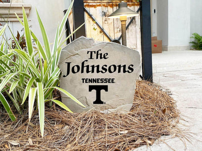 Decorative outdoor stone featuring Tennessee Vols logo and family name