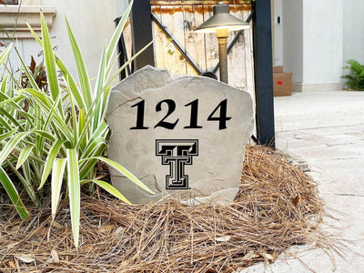 Engraved concrete rock with Texas Tech University emblem and address


