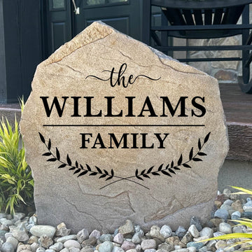 Personalized Family Name Leaf Stone featuring custom family lettering and elegant leaf accents engraved directly into the stone surface. This decorative garden stone enhances front yards, entryways, patios, and flower beds with timeless curb appeal.