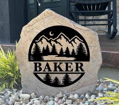 Personalized forest monogram stone with trees and mountains, perfect for outdoor décor.