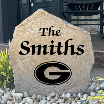 Officially licensed University of Georgia Name Stone featuring a personalized family name and the iconic Georgia Bulldogs logo engraved directly into the stone surface. This custom garden stone adds school pride and curb appeal to front yards, patios, gardens, and entryways.