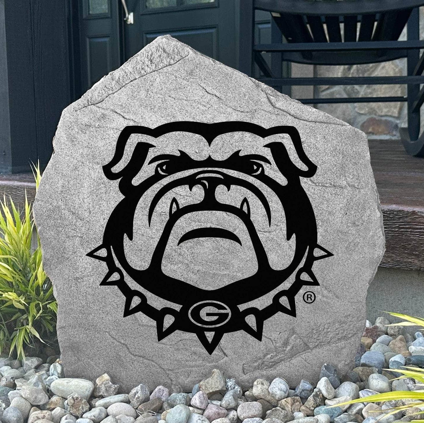Custom Georgia Bulldog Stone displayed in a landscaped flower bed, showcasing officially licensed Bulldog mascot artwork with permanent engraving. This outdoor accent creates a bold focal point for alumni homes and devoted Georgia fans.