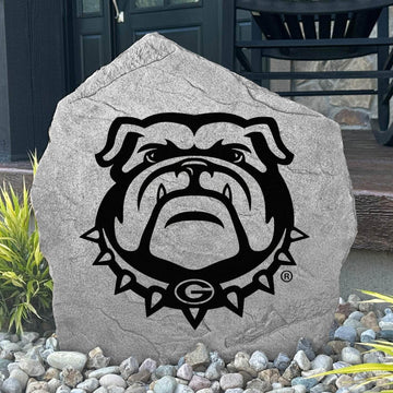 Custom Georgia Bulldog Stone displayed in a landscaped flower bed, showcasing officially licensed Bulldog mascot artwork with permanent engraving. This outdoor accent creates a bold focal point for alumni homes and devoted Georgia fans.